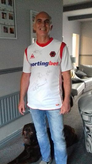 Paul Hawthorne wearing his Wolves top, signed by Rod Stewart and other celebrities