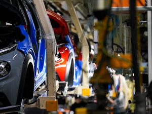 A row of cars being made at a Nissan plant