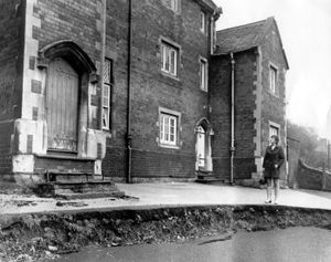 Subsidence at Ironbridge CofE School, on January 13, 1970. The school was also called Ironbridge 'Blue' School. Looking at it is parent Mrs Jennifer Kilshaw.