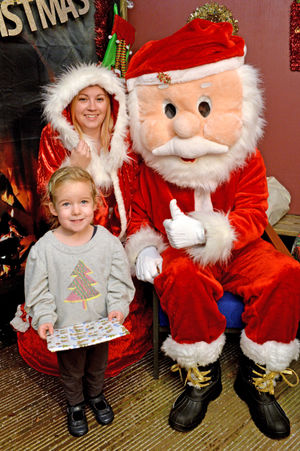 Children visiting the Landywood school Santa's grotto outside. Pictured left with Santa are Amelia Belsy age three and Charlie Titley