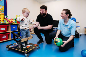 Archie Klein, two, from Market Drayton is able to stand up in front of father Steve Klein and physiotherapist Sarah Bew