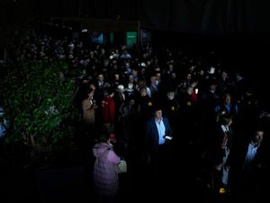 Spectators roam inside the Madrid Open tennis tournament venue during a general blackout across Spain and Portugal