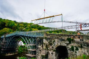 A crane lifts scaffolding into place on the old look Iron Bridge at the end of 2017