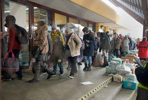 People walk in a line after disembarking from a Ukrainian train at the station in Przemysl, Poland