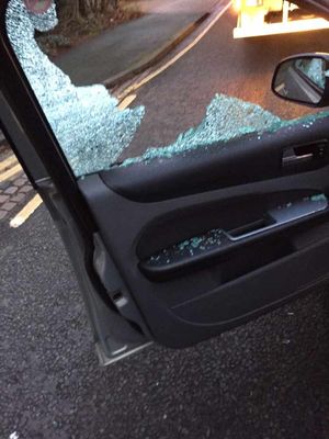 The shattered window of a taxi that was passing at the time of the blast