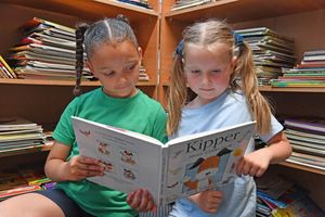 Year 2 pupils catching up on their reading in the school's library 