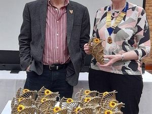 Kevin Reynolds and Anne Bumford with willow bird feeders 