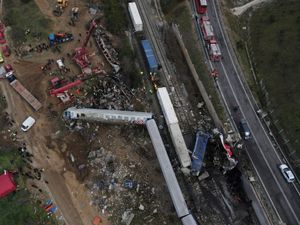 Firefighters and rescuers at the scene of a rail crash in Greece that killed 57 people