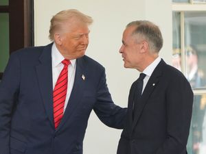 Mark Carney is greeted by Donald Trump (Mark Schiefelbein/AP)