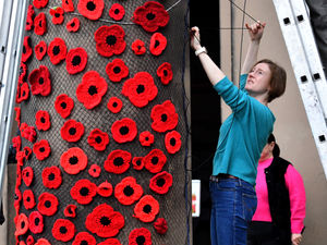 Supporting image for story: Watch: An 'Army' of yarn bombers adorn Shrewsbury church with poppies ahead of Remembrance Sunday
