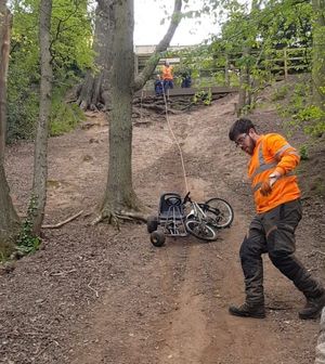 A Shrewsbury Town Council worker watches as rubbish is dragged up the bank from the old river bed