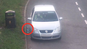 A driver dropped litter by a waste bin