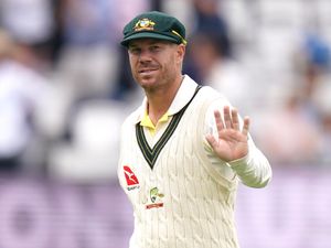 David Warner waves at the crowd while fielding at Lord's in 2023.