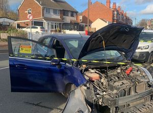 One of the vehicles was seen heavily damaged following the crash. Credit: West Midlands Fire Serivce