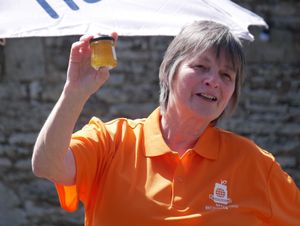 Judge Jane Maggs auctioning off the pot of the Japanese Gold winner marmalade, which made £25 for Macmillan Cancer Research