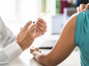 A doctor gives a patient an injection