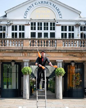 A lone busker completes an online challenge at an otherwise empty Covent Garden