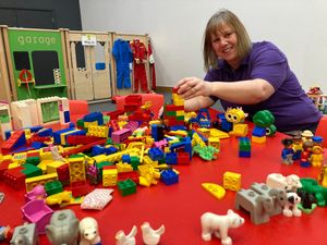 Volunteer Ruth Huskisson sets out equipment for the Friday playgroup sessions.