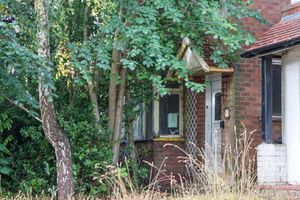 The house hidden behind foliage on Mavis Road in Longbridge, Birmingham. 