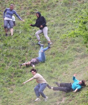 Contestants take part in the women's race of the annual Cheese Rolling Race at Coopers Hill in Brockworth, Gloucestershire this Bank Holiday Monday. May 26 2025.