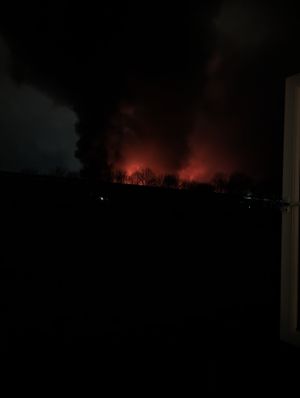 A vivid orange glow can be seen from the fire