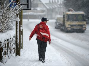 A postman makes his way through the snow. Picture: Jeff J Mitchell/Getty Images