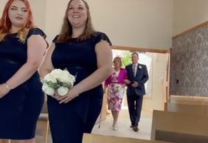 Sue and her brother walk down the aisle, led by Sue and Derek's daughters Rachel and Jodie who were bridesmaids