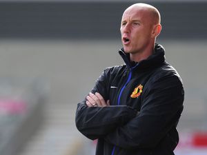 Former Manchester United midfielder Nicky Butt stands with his arms crossed wearing a United jacket