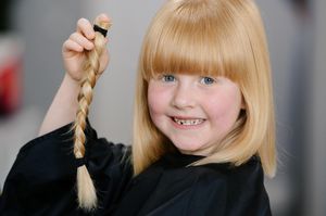 Polly Davis, six, has raised more than £500 for The Little Princess Trust after having eight inches chopped off her hair