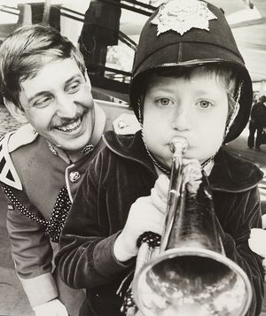 A display team from the Staffordshire Regiment was touring the West Midlands showing off aspects of military life. The photograph shows Adrian Preece of Fisher Street in Penn Fields trying out a bugle, alongside Lance-Corporal Tim Adams from Stoke, at the Mander Centre in May 1980.