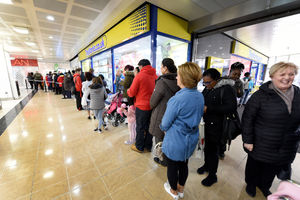 Shoppers queue for the opening of the store