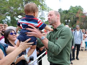 Supporting image for story: William cuddles baby as he samples island life on trip to Brazilian retreat