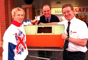 Derek, centre, with gymnast Craig Heap and Safeways manager Len Donnelly, for the draw of the Newport Cottage Care Centre raffle