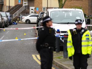 A police cordon at the scene on Gifford Road, Brent, after a woman has died and a man remains in a critical condition following a shooting in north-west London