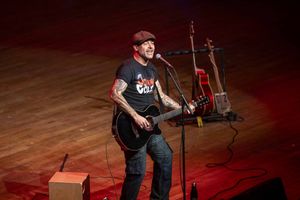 Jonny Cole performing a song with his guitar.