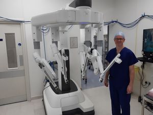 Consultant surgeon Mr Adam Farquharson beside the robot. Picture: LDRS