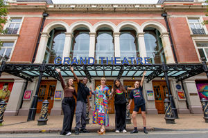 Jan Jennings from Richardson Brothers Foundation with head of community and creative engagement Nadia Abdelaal and young theatregoers outside The Grand Theatre