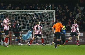 Jordan Thomas rifles a deflected shot past Tommy Simkin to equalise for Cheltenham.