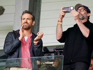 Supporting image for story: Hugh Jackman watches Wrexham game with Ryan Reynolds and Rob McElhenney