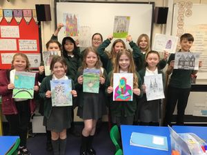 Pupils from Holly Grove Primary School in Burntwood with their artwork.