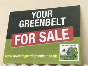 These signs were put up around the room at the public meeting 