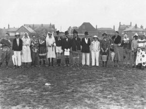 The picture was shared by Patrick Wood, it was from his father's archives. The date is 1935 and the picture was taken on the old Craven Arms football field which is now built on. The back of Barclays Bank, Coverdale Road, can clearly be seen in the background. The occasion is a charity football match. On the back of them the following caption on the one \ Fat Uns vee the Thin Uns \ and on the other \Thin Uns vee the Fat Uns\. Some characters from Craven Arms are mentioned...' (thepicture clearly shows the Thins team and the names he gives are 'in the Thins Jack Lloyd. Charlie Farr, Arthur Pendleton, Fred Smith Butcher, Tony, Croft 9th from left Mrs. Jane Wood my Grandmother Best Wishes Patrick Wood' jpwood13@gmail.com. Craven Arms footballers. Library code: Craven Arms nostalgia 2014.