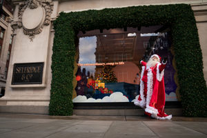 A man dressed as Santa Claus outside Selfridges in London as the department store unveils its Christmas windows on Oxford Street. This year's display is themed around 'Christmas of Dreams'. Photo: Aaron Chown/PA Wire