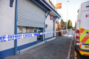 Police cordon off the shop and flat after the attack
