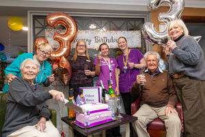 Residents Margaret Labazzi (left), Bill Shaw (right) and the Oxbow Manor team celebrate the home’s third birthday.