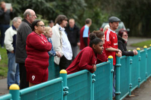 Supporters watch the match
