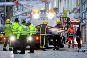 Firefighters carry away debris from Dudley Street near where Miss Martin died