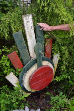 A wooden bird stands above one of the plaques.
