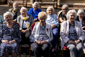 Ruth Bourne (centre) poses for a group photograph in front of Bletchley Park Mansion, as she returns to the scene of her wartime service at the annual Bletchley Park reunion at Bletchley Park in Milton Keynes.