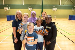 Youngsters taking part in the Yo! Active programme last summer with, left to right, Lisa Johnson, Service Manager for WV Active, Councillor Obaida Ahmed, Cabinet Member for Health, Wellbeing and Community, and Grace Whiston, Community Activation Officer, Wolves Foundation, for one of the activities at WV Active Bilston-Bert Williams.